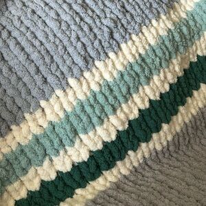 Handmade chunky knit baby blanket.  Light blue, grey, teal, periwinkle colours.